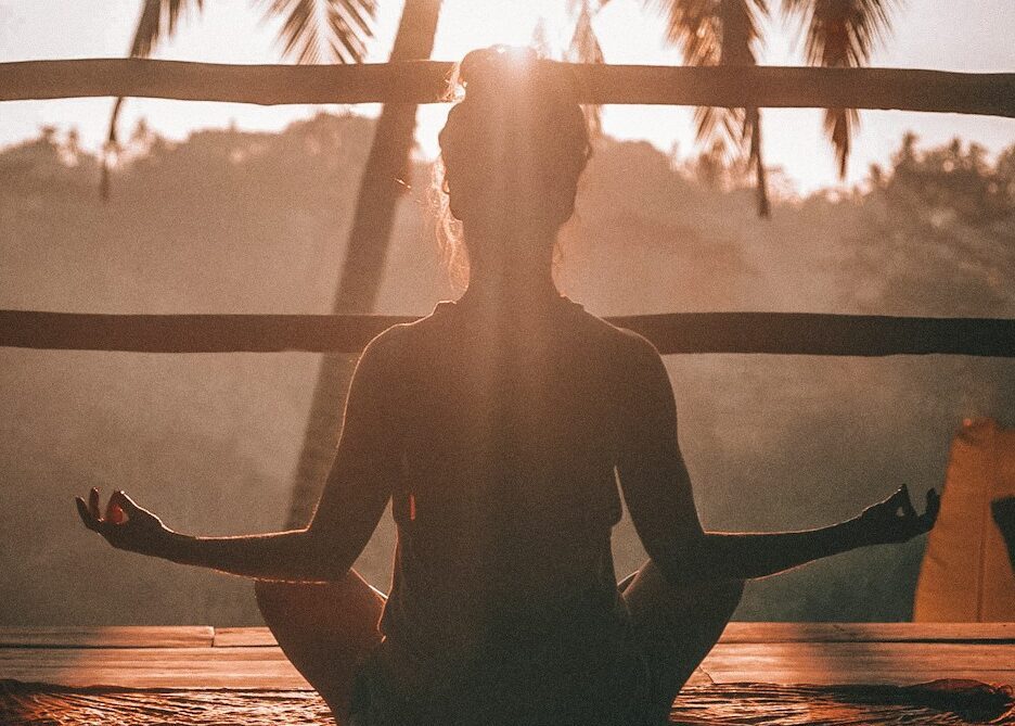 woman doing yoga meditation on brown parquet flooring